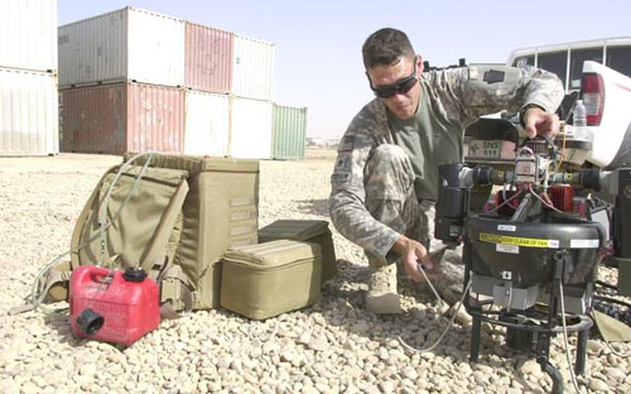 Staff Sgt. Todd Patterson, a member of the Pennsylvania guard&#39;s 56th Stryker Brigade Combat Team, sets up a GMAV -- a gas micro air vehicle -- at Camp Taji in Iraq. This small, unmanned aerial vehicle lets one soldier carry, assemble, fly and monitor an area individually. These prototypes, made by Honeywell, cost about $400,000 per system, which include two vehicles.