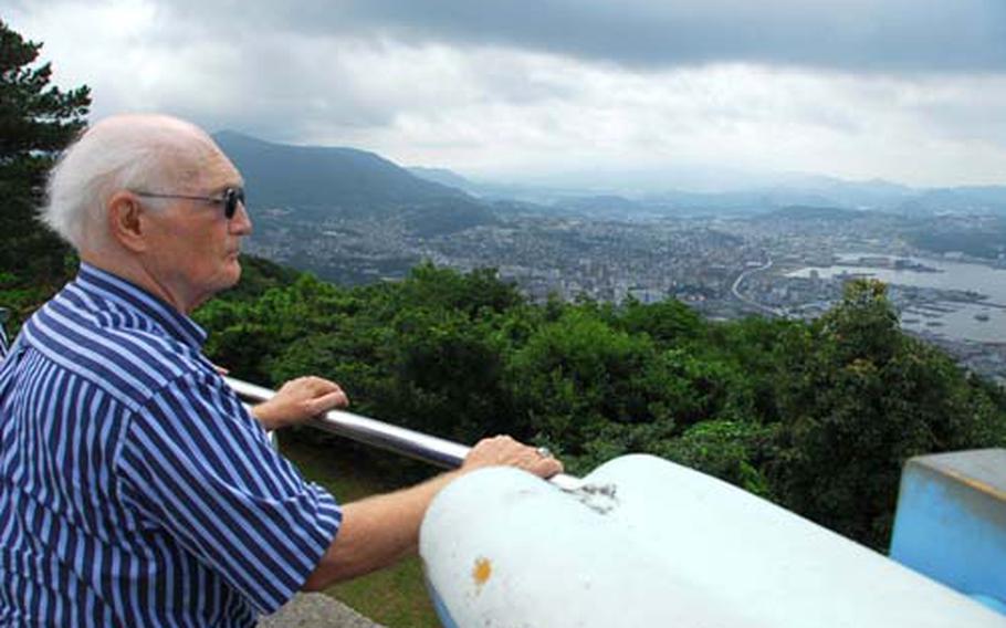 Retired Cmdr. Howard Benedict looks over Sasebo Naval Base, Japan, and the surrounding city. Benedict was 20 years old when he arrived in the area following the Japanese surrender in August 1945. On Tuesday, he returned to Sasebo for the first time.