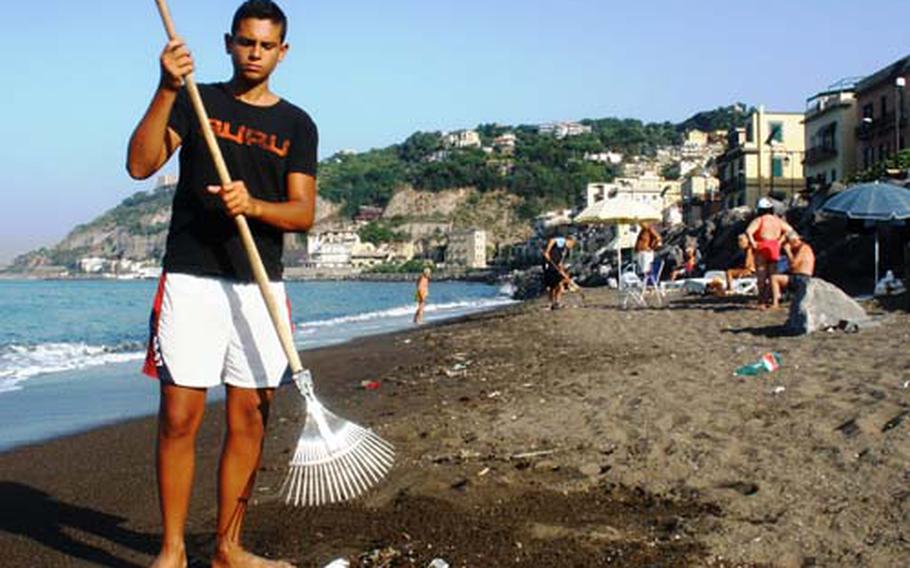 Each morning during the summer months, Rosario Calise, 15, cleans up a beach in Bagnoli, Italy. Recent news of polluted regional waters has depleted the throngs of sunbathers who usually show up, he said, though there are still a few dedicated beachgoers who turn out.