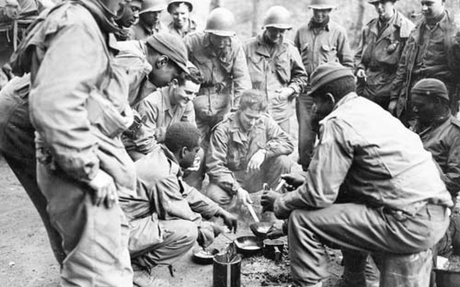 Tankmen of the 761st Tank Battalion and infantrymen of the 3rd Battalion, 409th Regiment, 103rd Division, 7th U.S. Army, make pancakes together near Reisdorf, Germany, on April 3, 1945. The image is part of a gallery of photos for a research project by historians Maria Höhn and Martin Klimke documenting the stories of black servicemembers in postwar Germany and how those experiences helped shaped the civil rights movement in U.S. and abroad. The researchers are looking for more black veterans to share their stories.