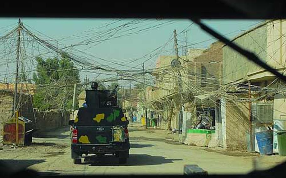 Iraqi police patrol through Karbala on July 11. U.S. troops from Task Force 2nd Battalion, 28th Infantry Regiment accompanied them.