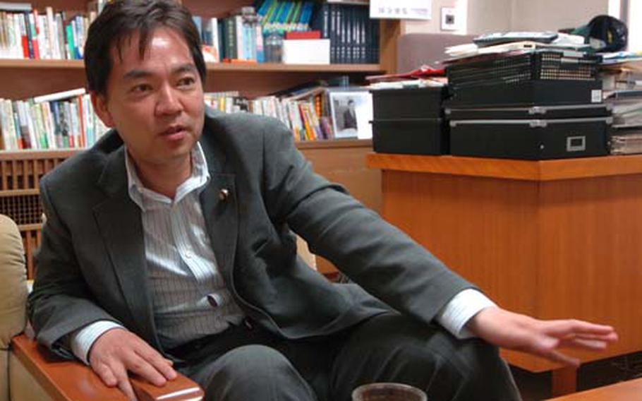Keiichiro Asao, the Democratic Party of Japan’s presumptive choice for defense minister if the party were to take control of the Japanese government, discusses the party’s vision on security issues at his Tokyo office Wednesday.