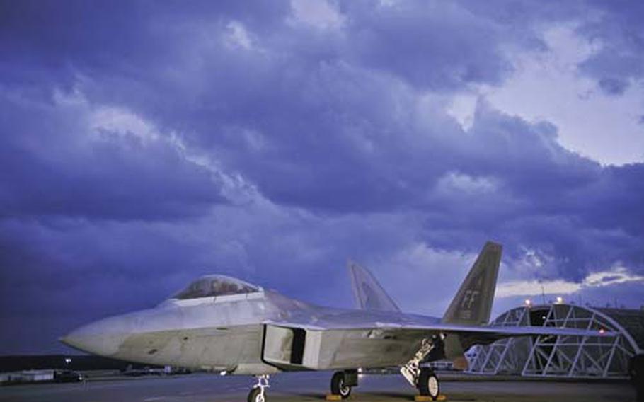F-22 Raptor pilot Capt. Brandon Zeurcher performs preflight functions Jan. 14 on the runway at Kadena Air Base, Japan. On Tuesday, the Senate voted to cut funding for seven new jets.