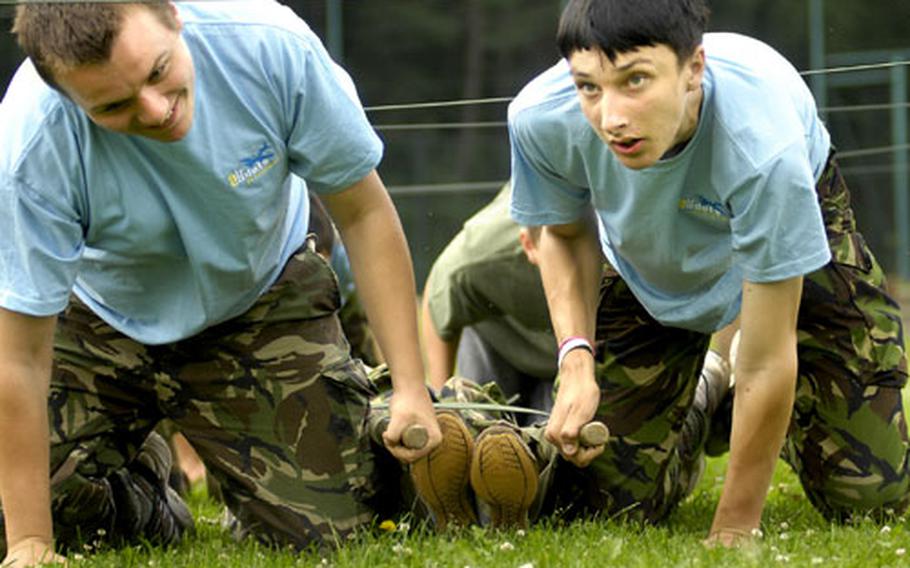 Alex Gliddon, left, and James Bennett, both air cadets from the United Kingdom, drag another cadet on a litter through an obstacle course Wednesday at Kapaun Air Station.
