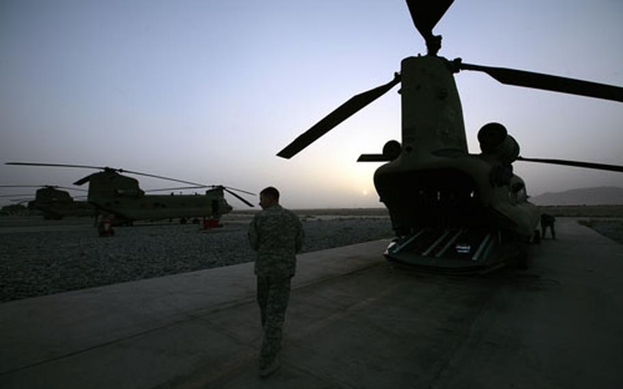 Crew members for a CH-47 Chinook helicopter assigned to the 82nd Combat Aviation Brigade prepare for an air assault mission on a recent night in Kandahar province, southern Afghanistan.