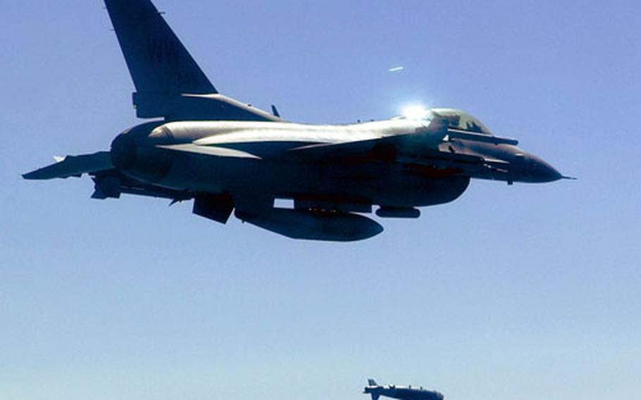 Col. RC Craig and Capt. James Cooke launch a joint direct attack munition GBU-38 inert bomb May 13 at Draughon Range in Japan.
