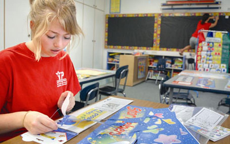 Olivia Flood, an incoming junior at Ramstein High School, helps second-grade teacher Sherry Brooks set up a classroom at Ramstein’s elementary school on Wednesday.