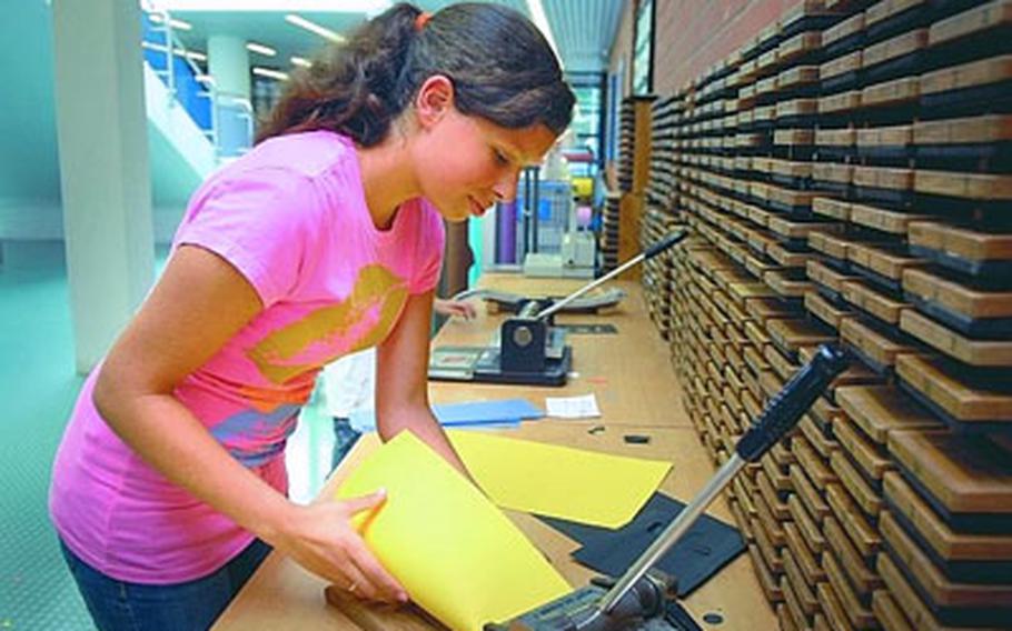 Lizzie Alonzo, 14, cuts out letters Wednesday for her mother’s classroom at Ramstein Elementary School. Lizzie’s mom teaches German immersion. New DODDS-Europe director Nancy Bresell hopes to expand foreign language programs.