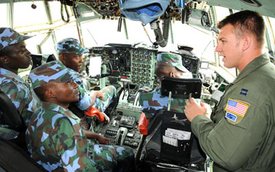 Capt. Kevin Graham, a 37th Airlift Squadron C-130 pilot, gives members of the Uganda Peoples’ Defence Air Force a tour of a C-130.