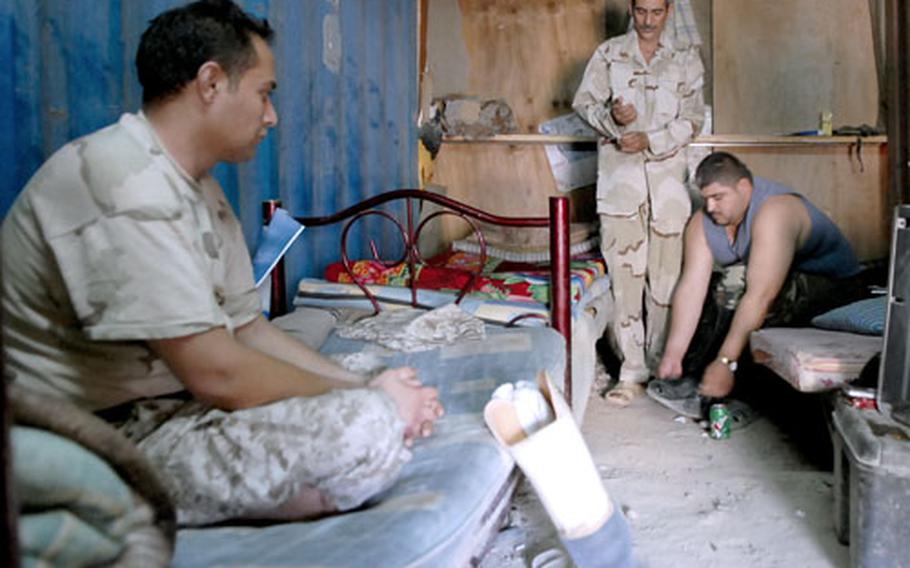 Wounded Iraqi soldiers Pfc. Qusay Aziz, Sgt. Hadi Ramadan and Pfc. Yahia Abud, left to right, live in a metal shipping container in Baghdad's Khadamiyah disctrict. There is no running water, and men use a field for a toilet.