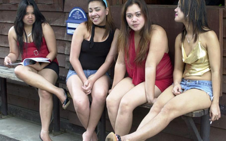 The women who work in the bars try to convince passing U.S. soldiers to come inside, where they keep the men company as long as the soldiers buy them expensive juice drinks.