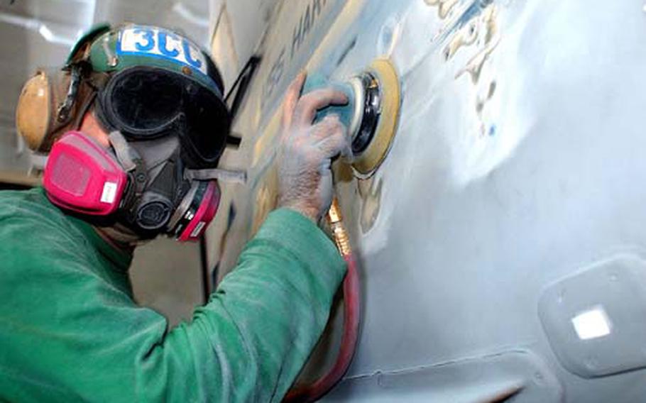 Petty Officer 3rd Class Ross Christie strips old paint from an F/A-18 Hornet in a hangar bay aboard the USS Harry S. Truman in this 2004 photo. Hexavalent chromium is commonly used as a corrosion inhibitor in paints and primers used by the military, but its toxic nature means it has become a topic of controversy.