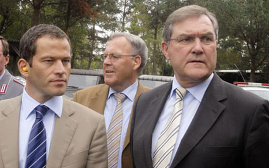 From left, Albert Rupprecht, a member of the German Federal Parliament from Weiden, Grafenwöhr Mayor Helmuth Wächter, and German Defense Minister Franz Josef Jung watch soldiers train at Grafenwöhr Training Area on Thursday. Wachter pushed the Hutten construction project with Jung.