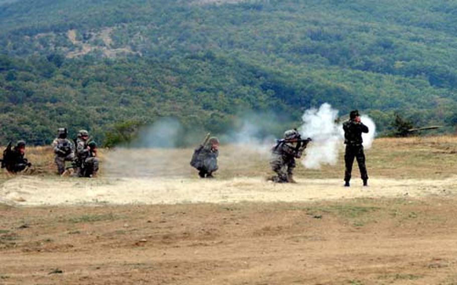 Pfc. Blake R. Ball, left, from the 2nd Stryker Cavalry Regiment based in Vilseck, Germany, fires a rocket-propelled grenade during training at Novo Selo Training Area, Bulgaria.