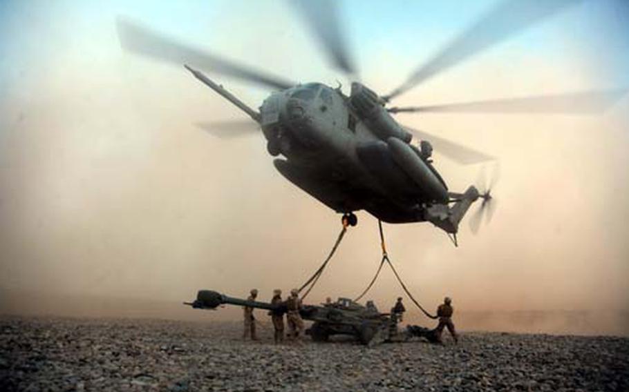 U.S. Marines with Combat Logistics Battalion 8 attach an M777A2 Lightweight Howitzer to a CH-53E Super Stallion at the helicopter landing zone at Fire Base Fiddler’s Green in Helmand Province, Afghanistan. The Marines transported three howitzers from 3rd Battalion, 11th Marine Regiment more than 75 miles to support 2nd Battalion, 3rd Marine Regiment’s operations in neighboring Nimruz province.