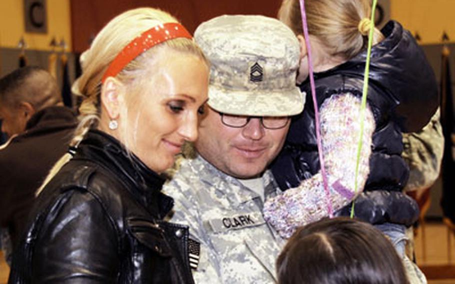 Master Sgt. David Clark of Headquarters and Headquarters Company, 16th Sustainment Brigade greets his wife, Olga, and daughters, Sofia, 3, right, and Liza, 8, at a welcome home ceremony Sunday morning on Warner Barracks in Bamberg, Germany. The 16th Sustainment Brigade was deployed for 15 months to Iraq and was the last Army unit to serve a 15-month tour there. Shortly after the unit arrived in Iraq, deployment lengths were shortened to 12 months.