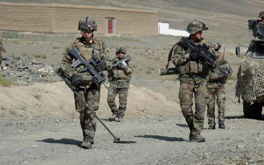 French Marine engineers sweep Tagab Valley Road northeast of Kabul in this October 2009 photo. France threaten Friday, Jan. 20, 2012, to withdraw early from Afghanistan after an Afghan soldier killed four French troops and wounded 15.