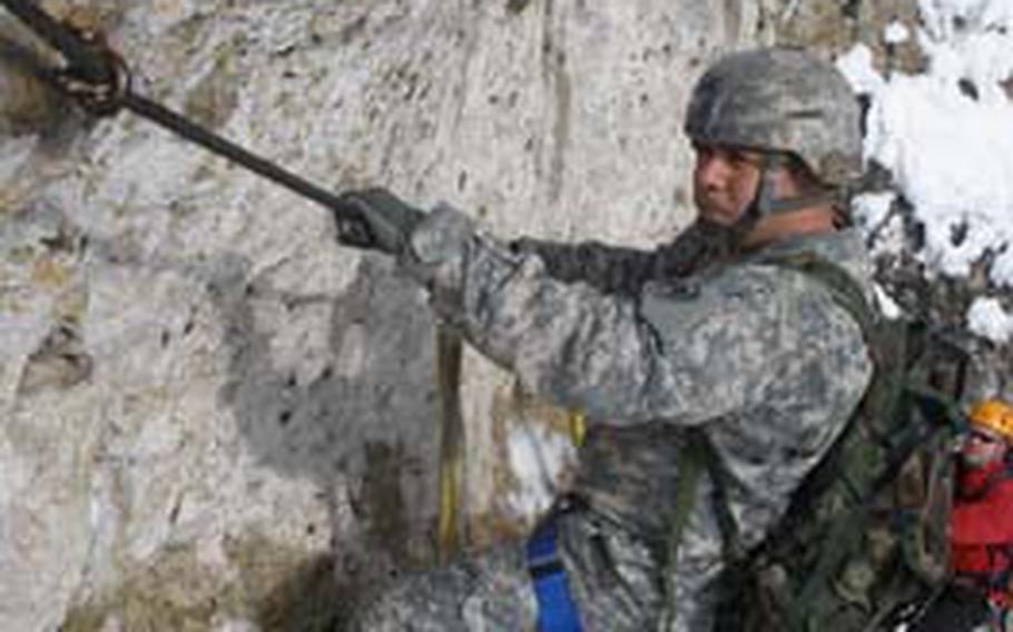 Staff Sgt. Reynaldo Jimenez, with the 2nd Stryker Cavalry Regiment, pulls himself along a cable during a rock-climbing trip in February 2009. The rec center at Grafenwöhr would provide as many of the activities in the Army’s Warrior Adventure Quest program as possible.