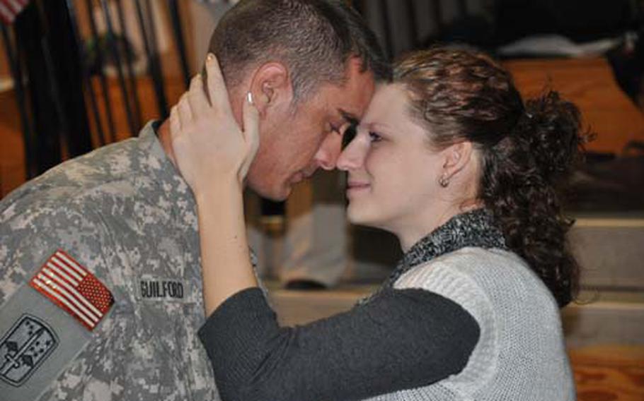 Sgt. Joshua Guilford is reunited with his wife, Sandra, as he returns from a 12-month deployment to Iraq with other members of the 1st Battalion, 2nd Infantry Regiment, 172nd Infantry Brigade Combat Team. The unit returned in the early morning on Veterans Day.
