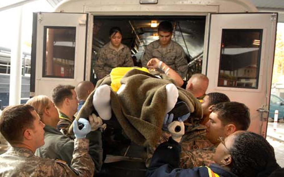 Soldiers, airmen and Navy medical personnel unload wounded inbound troops from Afghanistan last week at Landstuhl Regional Medical Center. The hospital has seen an uptick in wounded patients from Afghanistan in recent months, coinciding with a heavy number of deaths in the country.