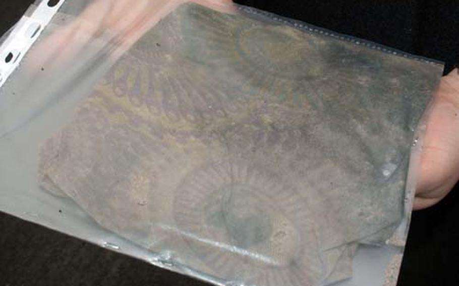 The remnants of a scarf presumably owned by the pilot of the P-47 that crashed into the Adriatic Sea during World War II -- were turned over to Air Force officials. It could help identify the pilot of the plane, which was brought up from the floor of the Adriatic earlier this year.