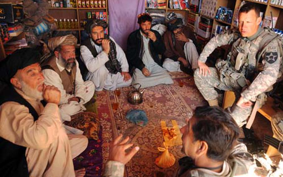 U.S. Army Lt. Col. Burton Shields, commander of 4th Battalion, 23rd Infantry Regiment, and his translator, hold a key leader engagement in Karezgay, Afghanistan, Oct. 31, 2009. The objective of the meeting was to ensure town elders of continued U.S. military and Afghan National Police support in the fight against the Taliban.
