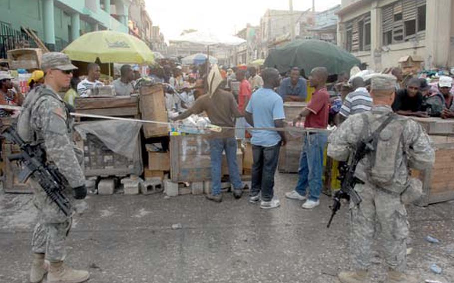 U.S. troops don’t wear body armor or helmets but carry loaded weapons during patrols in Port-au-Prince.