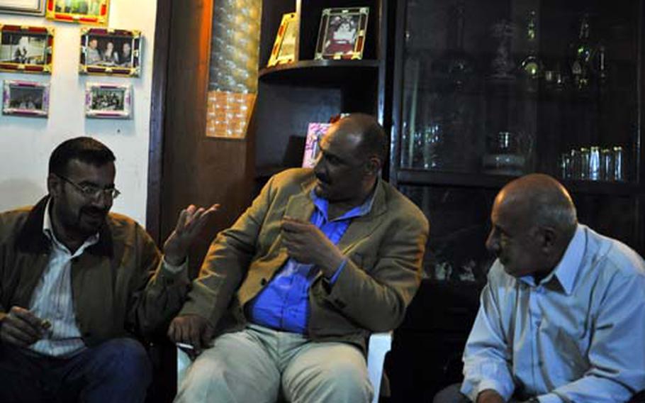 Hussein al-Najar, center, talks politics with his father, Majid al-Najar, right, and Jawadat Khamal at his home in Baghdad's Hay al-Amil neighborhood. Hussein al-Najar, a member of the Iraqi Communist Party, sees renewed hopes for Iraq's beleaguered secularists. Much of that optimism has gathered behind the candidacy of former Interim Prime Minister Ayad Allawi, seen as a viable challenger in Sunday's elections.