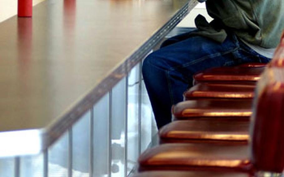 A patron sits for lunch at the popular Johnny Rockets fast food restaurant Tuesday at Ramstein's Kaiserslautern Military Community Center food court.