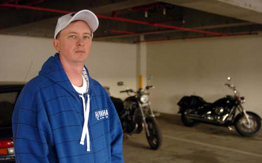 Chief Petty Officer Zachary Weymer returns to the long-term parking lot at Yokosuka Naval Base on Tuesday, where his $13,000 new motorcycle was stolen last year. Weymer was reimbursed only $3,000 for his loss, because he was unable to obtain theft insurance in Japan. Others who have either had their vehicles stolen or vandalized at the same garage say the base should provide better security for vehicles during ship deployments.