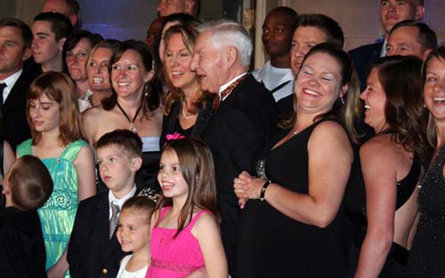 Family members who lost loved ones serving in the military get ready for a group picture Tuesday at the Tragedy Assistance Program for Survivors' annual fundraising gala Tuesday.