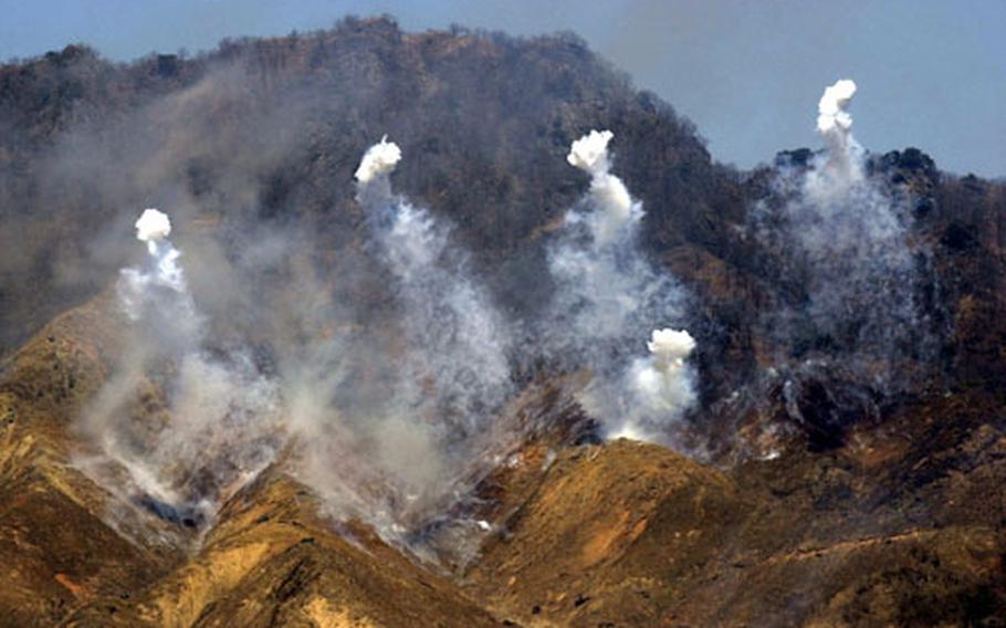 Smoke rises from explosions as targets on a hillside are fired upon during a live-fire training exercise Thursday at Rodriguez Range in South Korea.