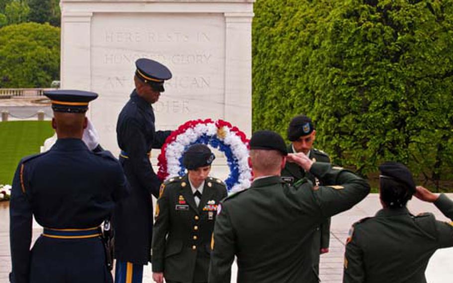 Staff Sgt. Courteney J. Fisher, center, and Specialist Tomas Garcia, far right, return to formation after laying a wreath at the Tomb of the Unknowns in at Arlington National Cemetery on Wednesday.