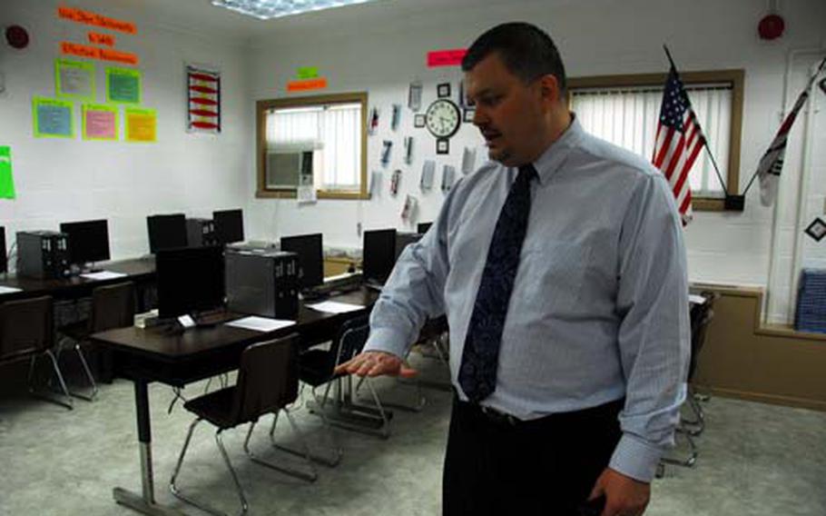 Seoul American Middle School prinicipal David Dinges describes the mold inside this computer lab before it was renovated last fall.