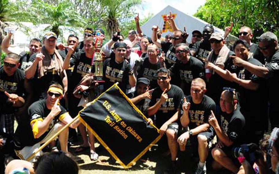 The Torii Knights celebrate after winning their heat in their race against two Okinawa teams at the 36th Naha Hari dragon boat races at Naha, Okinawa Wednesday. They set a blistering time of 5 minutes and 53 seconds. Japanese and U.S. military teams competed in heats of three boats, all brightly painted and resembling mythical sea dragons.