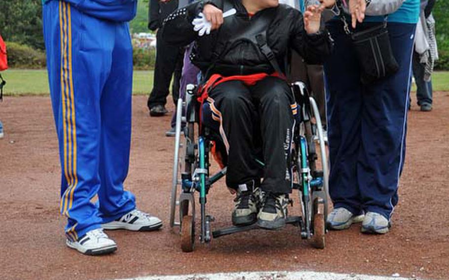 Jens Berger, center, celebrates his bocce ball throw with buddies Humphrey Mararo, left, and Tina Brevard.