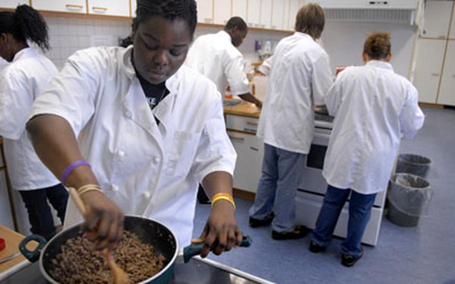 Amanda Flanagan, a junior at Baumholder High School, stirs up the sauce for a lasagna in January in culinary arts class. Amanda is a second-year culinary arts student.