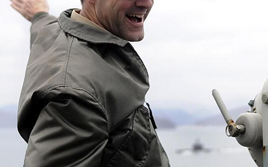 Vice Adm. John M. Bird, commander of U.S. 7th Fleet, waves at a South Korean submarine as U.S. 7th Fleet command ship USS Blue Ridge pulls into Chinhae Naval Base earlier this year during combined forces Exercise Key Resolve/Foal Eagle.
