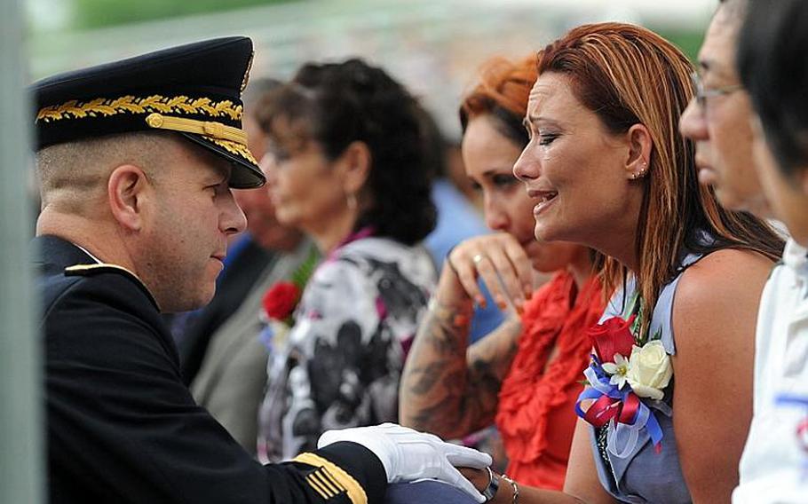 Sailors and family members attend the Navy Explosive Ordnance Disposal 41st annual Memorial Service in May at the Kauffman EOD Training Complex at Eglin Air Force Base, Fla. Under a new policy, the Navy will now pay the travel expenses of family members to attend a memorial service for their fallen sailor.
Jennifer A. Villalovos/U.S. Navy