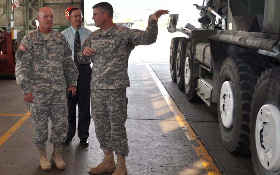 Col. Clay Hatcher, left, the U.S. Army Pacific?s chief of staff for logistics, is shown around the facilities of the U.S. Army Materiel Support Center-Korea at Camp Carroll on Sept. 13 by the center?s commander, Col. Phillip A. Mead, right, and Austin Anderson, MSC-K?s director for quality management. Hatcher?s visit came as part of a Pacificwide tour he?s making of Army logistical facilities. Incidental to Hatcher?s visit, Mead discussed his proposal that USARPAC consider sending some of its equipment maintenance load to MSC-K.
