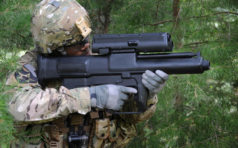 A soldier demonstrates the XM25 Counter Defilade Targeting Engagement System at Aberdeen Test Center, Md. The Army has begun testing and training with five of the prototype "smart" weapons in Afghanistan. The weapon fires rounds that can be programmed to explode on impact, in front of or behind an object. Limited production of the XM25 is expected to begin in 2012.