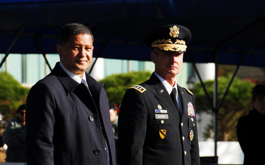 Hilton Dennis, South Africa's ambassador to South Korea, and U.S. Forces Korea commander Gen. Walter Sharp watch troops parade during a ceremony at U.S. Army Garrison-Yongsan on Tuesday, when South Africa was reinstated as a member of the U.N. Command. Sharp also heads the 16-member UNC.