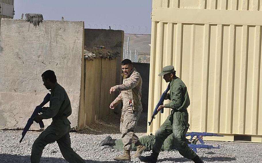 Before the 15 Marines stationed at the Adraskan police training center in Afghanistan's Herat province could enjoy their holiday Thursday, there was work to be done. Lance Cpl. Mark McCart, 19, of Fountain, Colo., took some recruits through the motions Thursday morning.