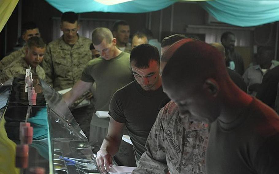 Marines go through the Thanksgiving chow hall line Thursday at the Adraskan police training center in Afghanistan's Herat province.