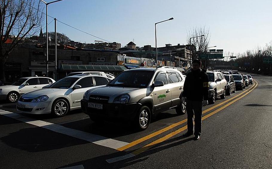Traffic sits at an intersection just outside U.S. Army Garrison-Yongsan on Friday afternoon during a 20-minute civil defense drill. Such drills are held regularly but usually receive little attention, unlike Wednesday's drill, which comes three weeks after the North Korean bombardment of a South Korean island.