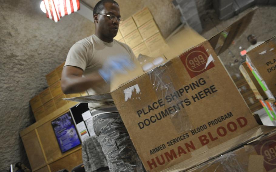 Air Force Tech. Sgt. Anthony Williams, 37, of Bernice, La., inspects a shipment of blood headed to battlefield hospitals in Iraq and Afghanistan. Williams works at the Al Udeid Air Base blood center outside of Doha, Qatar, which processes nearly every drop of blood headed to U.S. troops in harm's way.