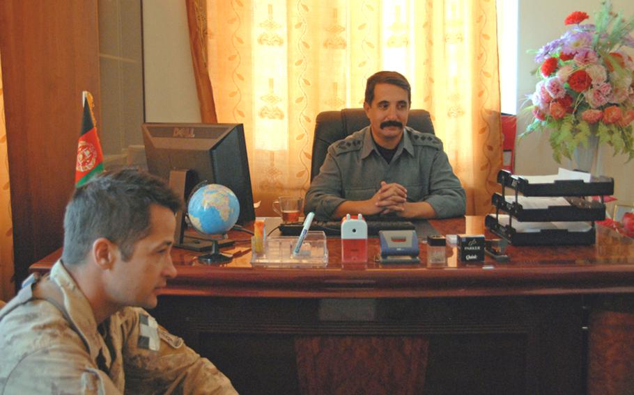 Col. Shir Shah, the Dand district chief of police, in his office during a meeting with a Coalition soldier about ways to improve his police force. Shir Shah is struggling to maintain authority after a deal brokered by coalition forces integrated the militias of two powerful strongmen into his force.