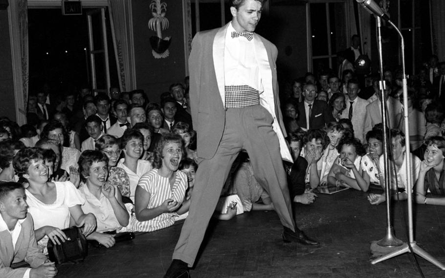 Airman 2nd Class Gus Backus, a New York native who works as an electrocardiograph technician at the Wiesbaden Air Force Hospital, entertains the crowd at the Rock 'n' Roll-o-Rama.
