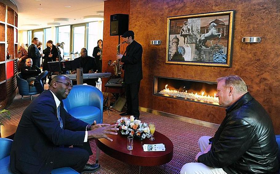 Guests at the official opening of the Wiesbaden Army Lodge enjoy live music and the fireplace after the ribbon-cutting on Wednesday.