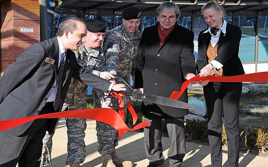 Lodge manager Jim Weber, U.S. Army Garrison Wiesbaden commander Col. Jeffrey Dill, Lt. Col. John Drew, deputy commander of the Army Corps of Engineer&#39;s Europe district, Wiesbaden lord mayor Helmut Mueller and Luise Hoelscher, undersecretary of the Hesse ministry of finance, from left, cut the ribbon to officially open the Wiesbaden Army Lodge.